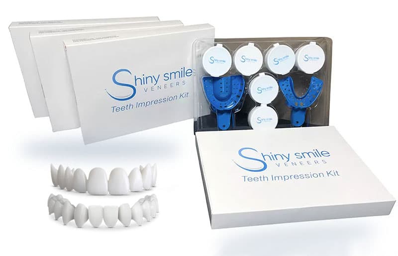 Person placing Shiny Smile veneers over their natural teeth