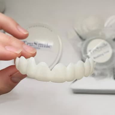 TruSmile snap-on veneers held in hand